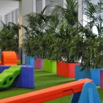 Urban12s with Ficus and Kentia Palm Urban12s with Ficus and Kentia Palm surround the play area.